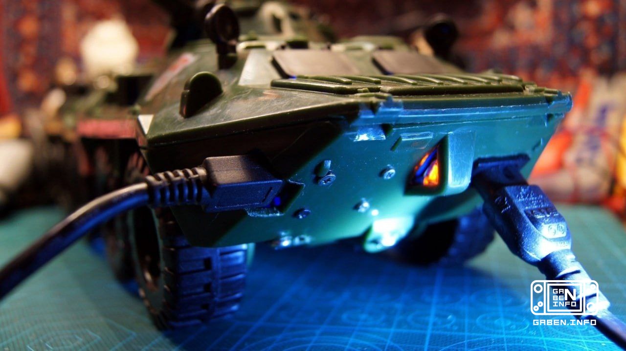 A retro gaming harvester assembled in the body of a toy armored personnel carrier.
